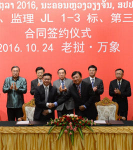 Director General of Laos-China Railway Company Zhao Xiang (R, front) shakes hands with a representative of China's Sinohydro Corporation Ltd. in Vientiane, capital of Laos, Oct. 24, 2016.